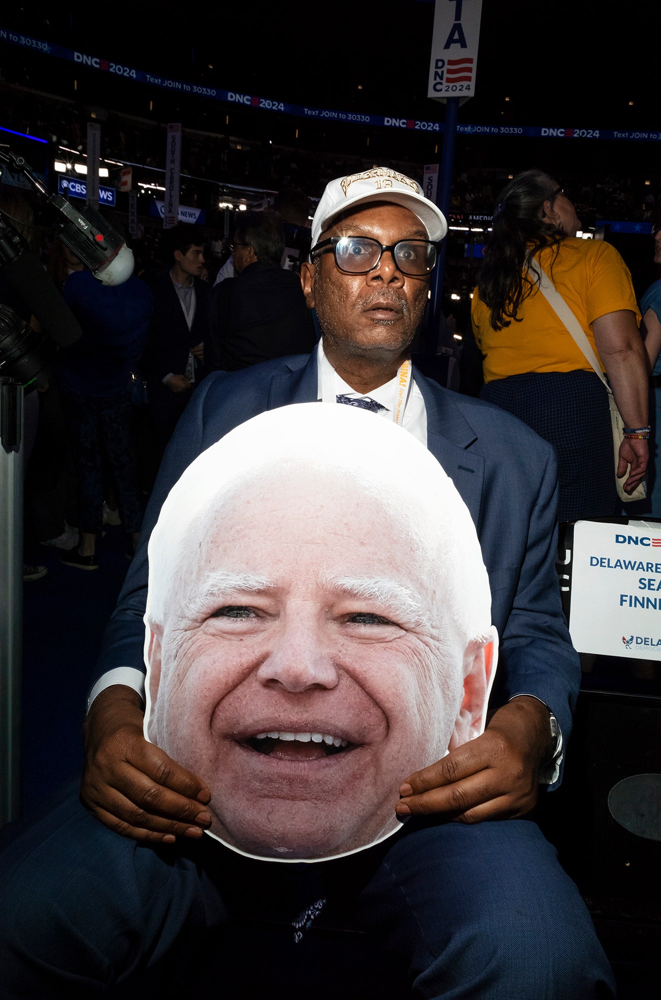 Image may contain Tim Walz Face Head Person Photography Portrait Accessories Glasses Clothing Coat Jacket and Hat