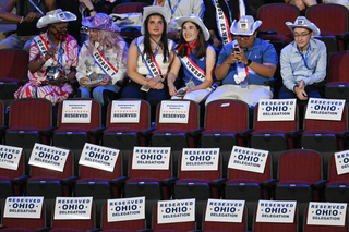 Image may contain People Person Adult Child Chair Furniture Clothing Hat and Crowd